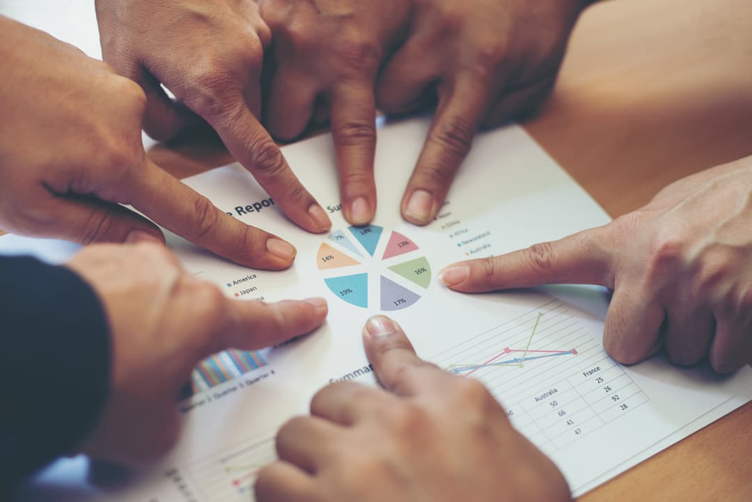 people pointing to a graph.